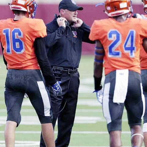 Mike Jackson (center, coaching Conroe Grand Oaks) is returning to the place of his first coaching stop, Shiner St. Paul, to once again lead the Cardinals football team. Photo courtesy of Mike Jackson.