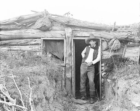 A cowboy at the entrance of a dugout in Texas, 1907.  Image courtesy of Amon Carter Museum.