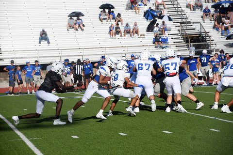 The Yoakum first-team offense executes a running play. Photo by Mark Lube.