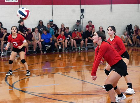 Faith Brown (middle) sets up for a defensive play with Karis Barta (left) and Reese Seibert (right) backing up during a St. Paul JV match against Flatonia on Aug. 15.. Photo by Mark Lube. 