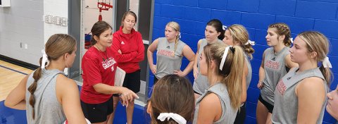 St. Paul  head volleyball coach Nicco Brown (second from left) and assistant coach Karli Rodriguez (third from left) talk things over with the Lady Cardinals Friday in a scrimmage at Yoakum. Photo by Nadine Rex/Yoakum Herald-Times.