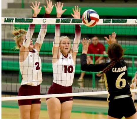 The Halatas (not sisters) Alaina Halata (2) and Grace Halata go up for a block against Calhoun. Chuck Grafe/Tribune-Herald