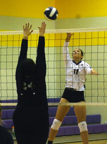 Faith Academy attemtpts to block a kill attempt by Brooke Palmer. Palmer had two kills and one block. Photo by Mark Lube.