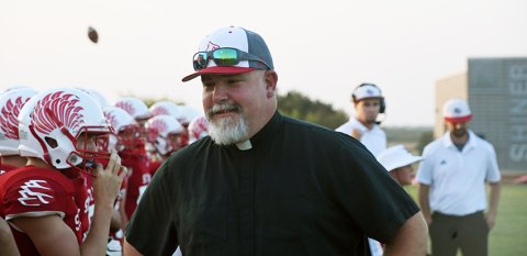 The Rev. Bryan Heyer was on hand to support the Cardinal football team in their win over TMI on Friday.. Photo by Mark Lube.