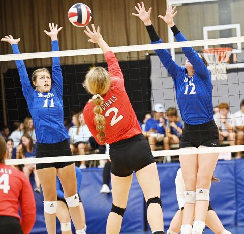 Tori Walker (center) tries to place her kill attempt to split Sacred Heart blockers Mallory Mueller (left) and Annika Brooks (right) Thursday night in Hallettsville. Photo by  Chuck Grafe/Hallettsville Tribune-Herald. 