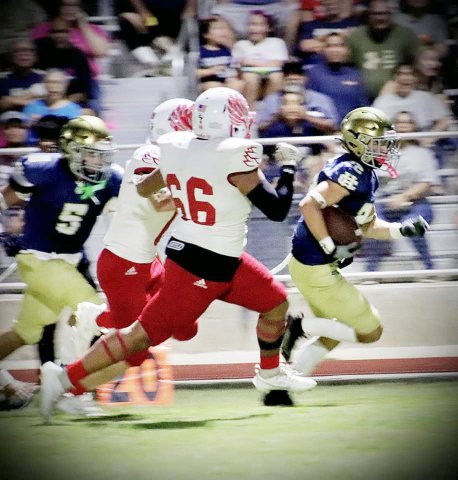 Zeke Basquez (66) and a teammate chase down a Holy Cross ball carrier Friday night in San Antonio. Photo courtesy of Brian and Louann Heinsohn.