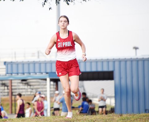St. Paul senior cross-country athlete Brooke Cerny finished off her high-school tenure with  a bang, finishing first in the TAPPS 2A state race on Monday and leading St. Paul girls to  second-place finish. She is shown here running at Shiner Sept. 16 Shiner Meet. Photo by Mark Lube. 