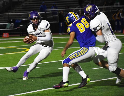 Bode Werner (left) looks to avoid some trouble against Freer last Friday. Werner scored two touchdowns and was 4-of-5 on extra-point attempts.  Photo by Mark Lube.