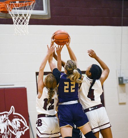 A pair of Lady Brahma defenders try to corral a shot by Shiner’s Addy Siegel Nov. 20 in Hallettsville. Siegel scored six as Shiner won 41-34. Photo courtesy of Chuck Grafe/Hallettsville Tribune-Herald.