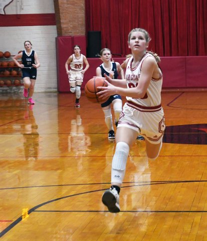 Skylar Mozisek with a first half drive in the lane Dec. 5 against Faith Academy. She contributed 10 points in St. Paul’s 55-11 non-district win over the Lady Cougars. Photo by Mark Lube.