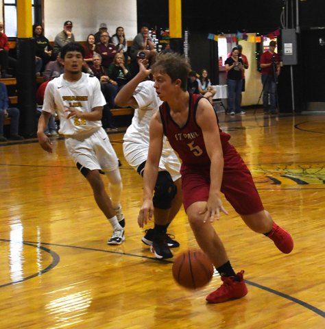 Jack Leonard makes his way inside in the Cardinal’s game against Prairie Lea. He sank two points in the win. Photo by Mark Lube.