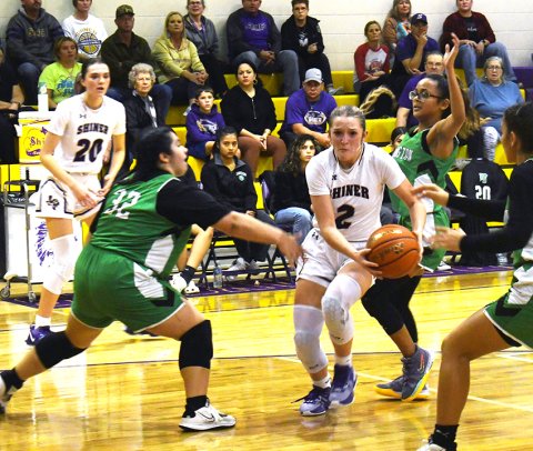 Shiner’s Callie Sevcik draws the attention of two or three Bloomington players near the basket during first-half action of the Lady Comanches’ home game on Friday. Sevcik was the second-leading scorer for Shiner with 10 points. Photo by Mark Lube.