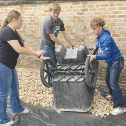 Pictured are Yoakum High School students helping to level rocks on school grounds. Contributed photo.