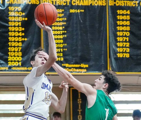Shiner’s Kade Remschel puts up a shot despite a Boling  player (hand) literally in his face Friday morning in the Round Top-Carmine Tournament. Photo courtesy of Howard Esse.