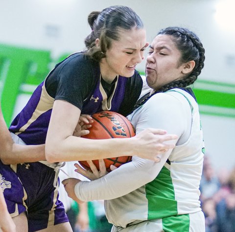 Morgan Lenehan attempts to wrestle possession away from a Bloomington player Jan. 23 in Bloomington. Photo courtesy of Howard Esse.