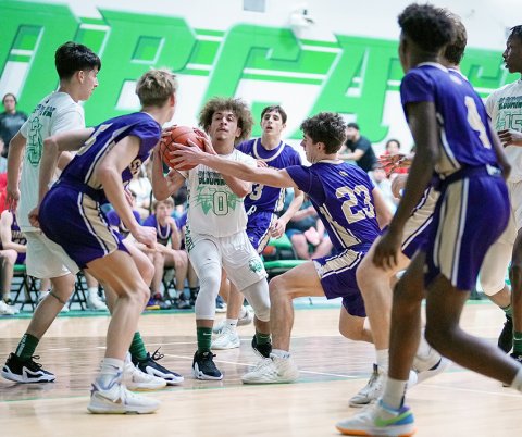Shiner players Boe Boehm, Jake Simper, Carson Schuette and Quincy Jones play some defense in the Comanche’s win at Bloomington on Jan. 23. Photo courtesy of Howard Esse.