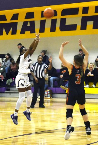 Jaliyah Barnett puts up an outside shot during the first half. She converted a three-point attempt later in the game. Photo by Mark Lube.