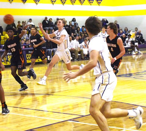 Boe Boehm flings a quick pass to a teammate close to the Schulenburg basket. Photo by Mark Lube.