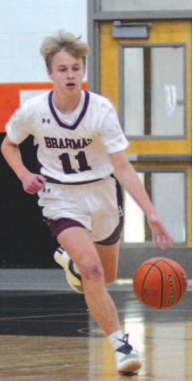 Shane Migura brings the ball up court vs. Schulenburg. Chuck Grafe/Tribune-Herald