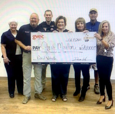 Police Officers accept grant money in the amount of $20,000 from GVEC members