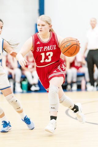 Maurin Knesek pushes the ball down the court in St. Paul’s away game at Sacred Heart on Feb. 5. Photo courtesy of Photos by Lori Raabe.