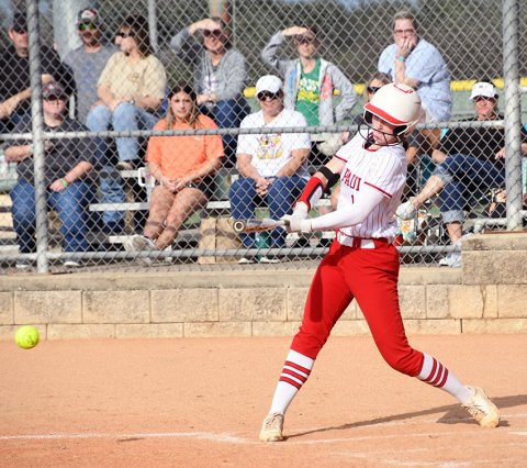 Tatum Walker smashes the ball against Moulton on March 12. She had one of St. Paul’s two home runs. Photo by Mark Lube.