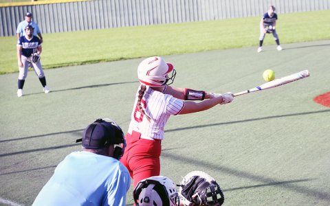 Jessica Fikac makes contact in the second game. The junior hit an in-the-park home run and had five total RBI. Photo by Mark Lube.