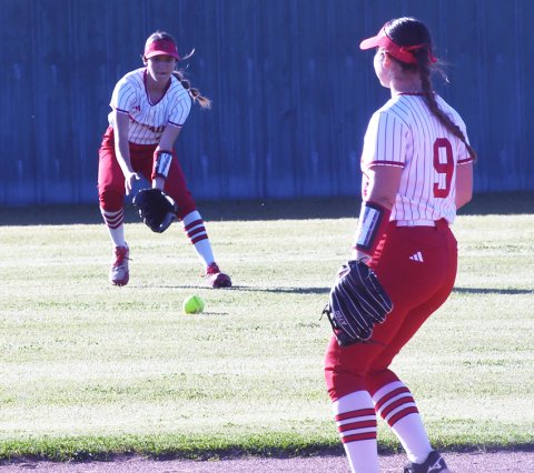 St. Paul centerfielder Brooke Cerny lasers in on a ground ball while Stefany Pokluda, second baseman, provides support. Photo by Mark Lube.