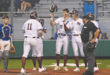 Josh Griffin (11) is greeted at home plate after his three-run homer in the third inning in Game 1. Chuck Grafe/Tribune-Herald