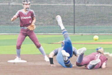 Lady Brahma second baseman Madison Mikes takes a tumble after being run over by Natalia’s Cindy Jimenez, who was called out for interference. Chuck Grafe/Tribune-Herald