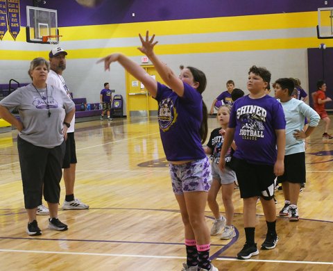 Campers work on shooting under the watchful eyes of Peterson (head girls coach) and Jeff Akin (head boys coach). Photo by Mark Lube.
