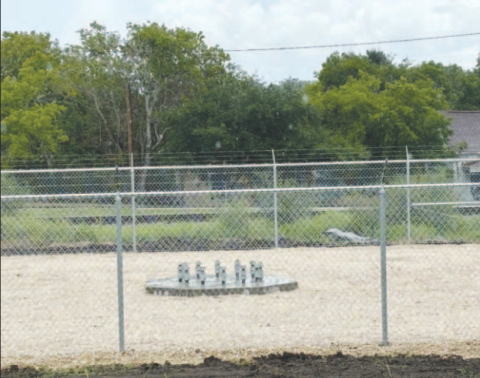 The new cell tower will be located across from Block 2 next to 701 Front Street. The concrete foundation is poured along with a perimeter fence around it. 