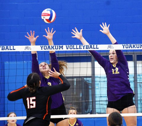 Chesney Machacek (left) and Harlee Sevcik attempt to block a hit by Gonzales’ Bella Ikard in the Lady Comanches’ sweep of Gonzales Aug. 13 in Yoakum. Photo by Mark Lube.