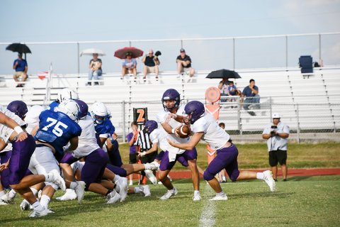 Carson Schuette and Caleb Lehnert meet at the “mesh point” on a triple-option play against TIdehaven . Photo by Mark Lube.