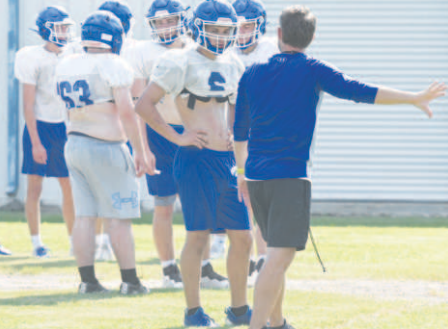 Indian assistant coach Randy Kaiser instructs Kellen Mechura at Monday’s practice. Chuck Grafe/Tribune-Herald