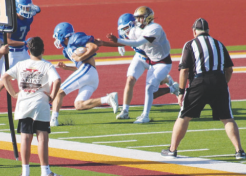 Clayton Haas, with the aid of a block by Ty Noska, scores the only touchdown in the scrimmage. Lisa Noska for the Tribune-Herald