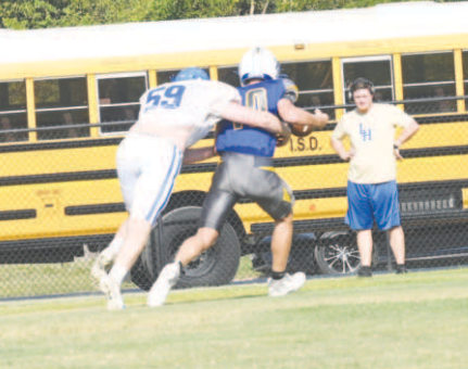 Brody Etzler records a sack in Thursday’s scrimmage with Louise. Chuck Grafe/Tribune-Herald