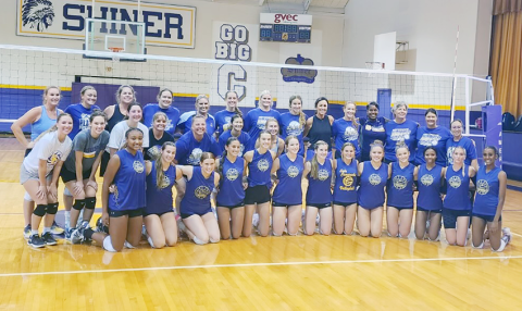 Alumni and current varsity players gather for a group shot after the match. Photo courtesy of Desiree Nitsch.