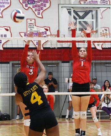 Dallyn Pesek (left) and Riley Mozisek attempt to block a Yorktown kill attempt on Aug. 27. Photo by Mark Lube.