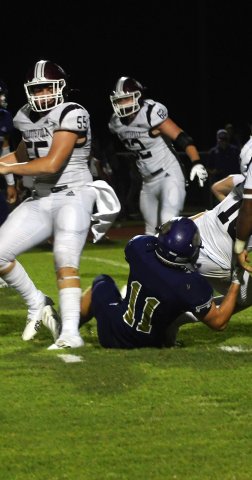 Kye Adamek pulls down Hallettsville quarterback Mycole Pegoda. Photo by Mark Lube.