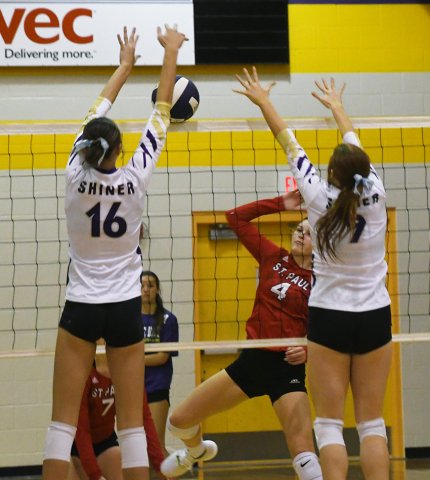 Morgan Lenehan (left) and Lexi Boner with a block attempt at the net for Shiner during their match Sept. 10 against St. Paul.  Photo by Mark Lube.