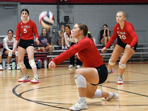 Faith Brown (foreground) receives a serve with Erin Hajek (background left) and Emery Kennedy (background right) providing cover in the match against San Antonio Antonement. Photo by Mark Lube.
