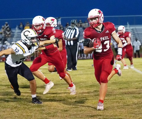 Gus Collins runs by a teammate blocking a Centurion defender. Collins ran for 97 yards, including a 63-yard touchdown on the game’s first play.Photo courtesy of Photos by Lori Raabe.