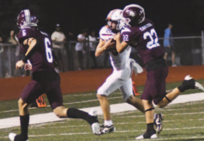 Jesse Cavazos (22) makes the tackle on Apache quarterback Tyler Hoffman. Chuck Grafe/Tribune-Herald