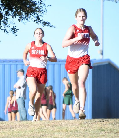Kristin Cerny (left) and Skylar Mozisek (right) got the first two places of the varsity girls 1A-2A race to lead St. Paul to the team title. Photo by Mark Lube.