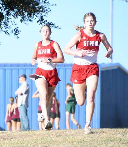  Kristin Cerny (left) and Skylar Mozisek (right), shown here at the Sept. 28 Shiner meet, led the Lady Cardinals XC team to their first state 2A title since 2021 after placing sixth and third, respectively. Photo by Mark Lube.