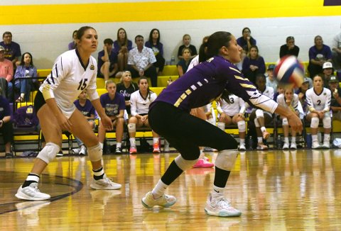 Kylynn Ramirez receives a Weimar serve while sister Brinley Ramirez looks on. Photo by Mark Lube.