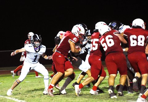 Sam Perez heads into a pile during the second quarter against Conroe Covenant Christian while offensive linemen Jackson Seibert (55), Brody Biehunko (56) and Gage Anders (68) occupy Covenant defenders. Photo by Mark Lube.