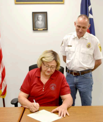 Fire Prevention Week is Oct. 6 through 12 and this year’s theme is “Smoke alarms: Make them work for you”. The week focuses on educating people about having workable smoke alarms in the home. Seated and signing the proclamation is Hallettsville mayor Alice Summers with Hallettsville Volunteer Fire Department chief Stephen Grahmann present for the signing. Photo by Jimmy Appelt