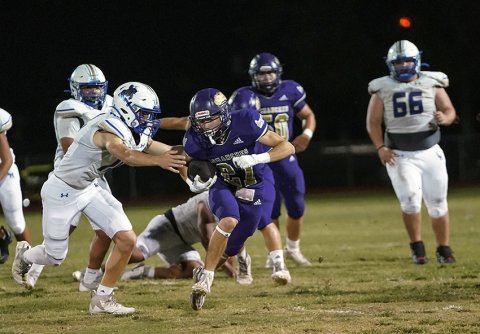 Caleb Cowan fights his way out of the grasp of a Louise defender Friday night in Shiner. He had a single carry for 14 yards to add to Shiner’s 329 rushing yards. Photo courtesy of Photos by Lori Raabe.